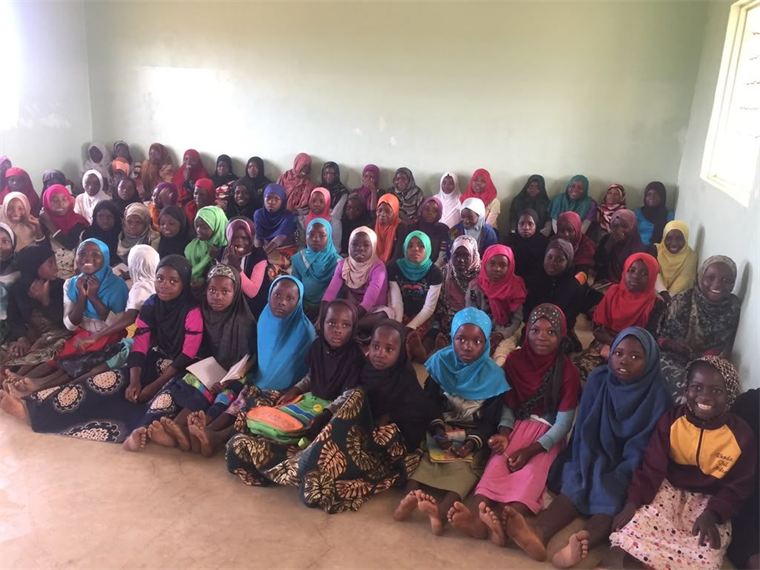 Girls' learning group seated together in a classroom during education fieldwork in Malawi