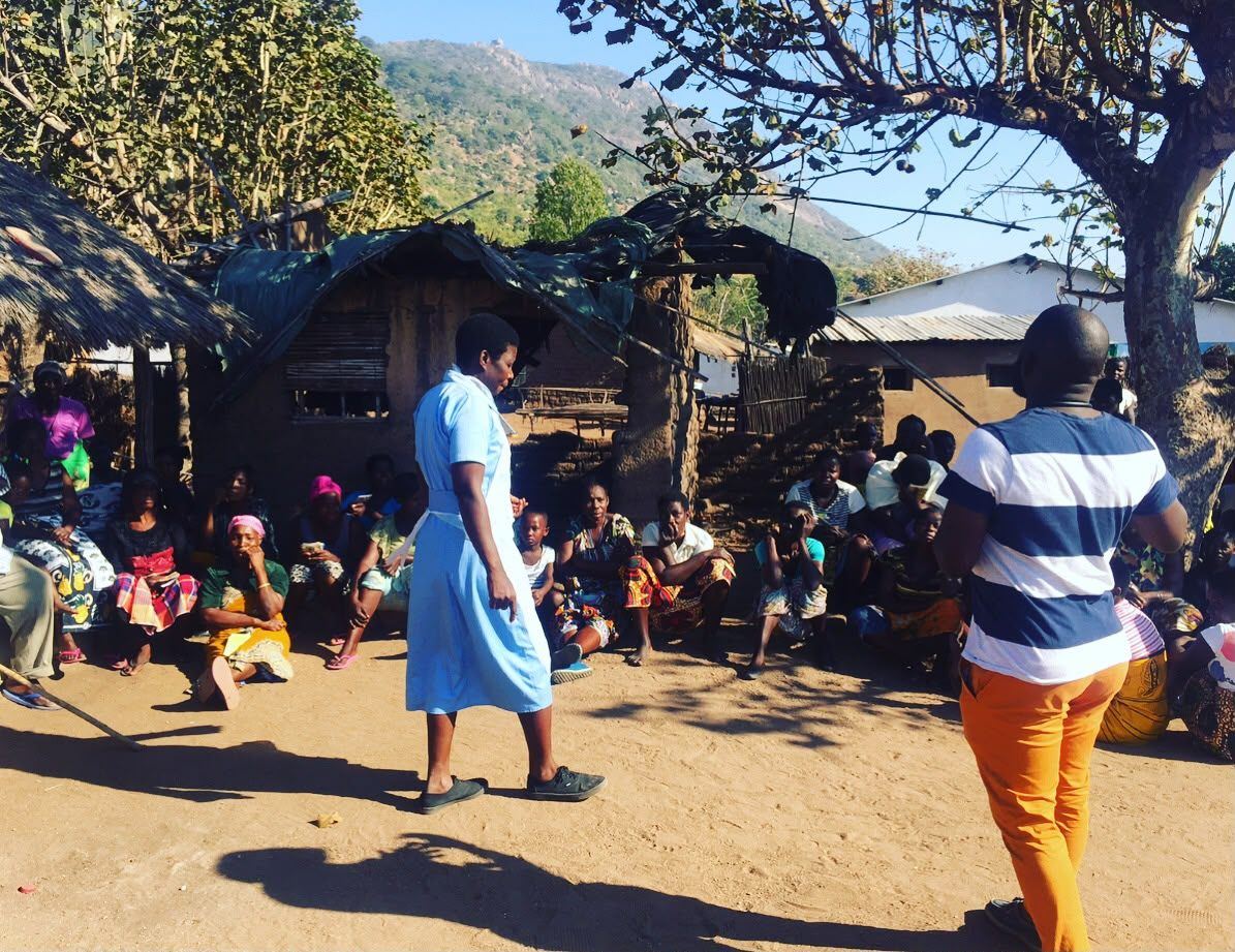 Focus group discussion with community members seated together outdoors