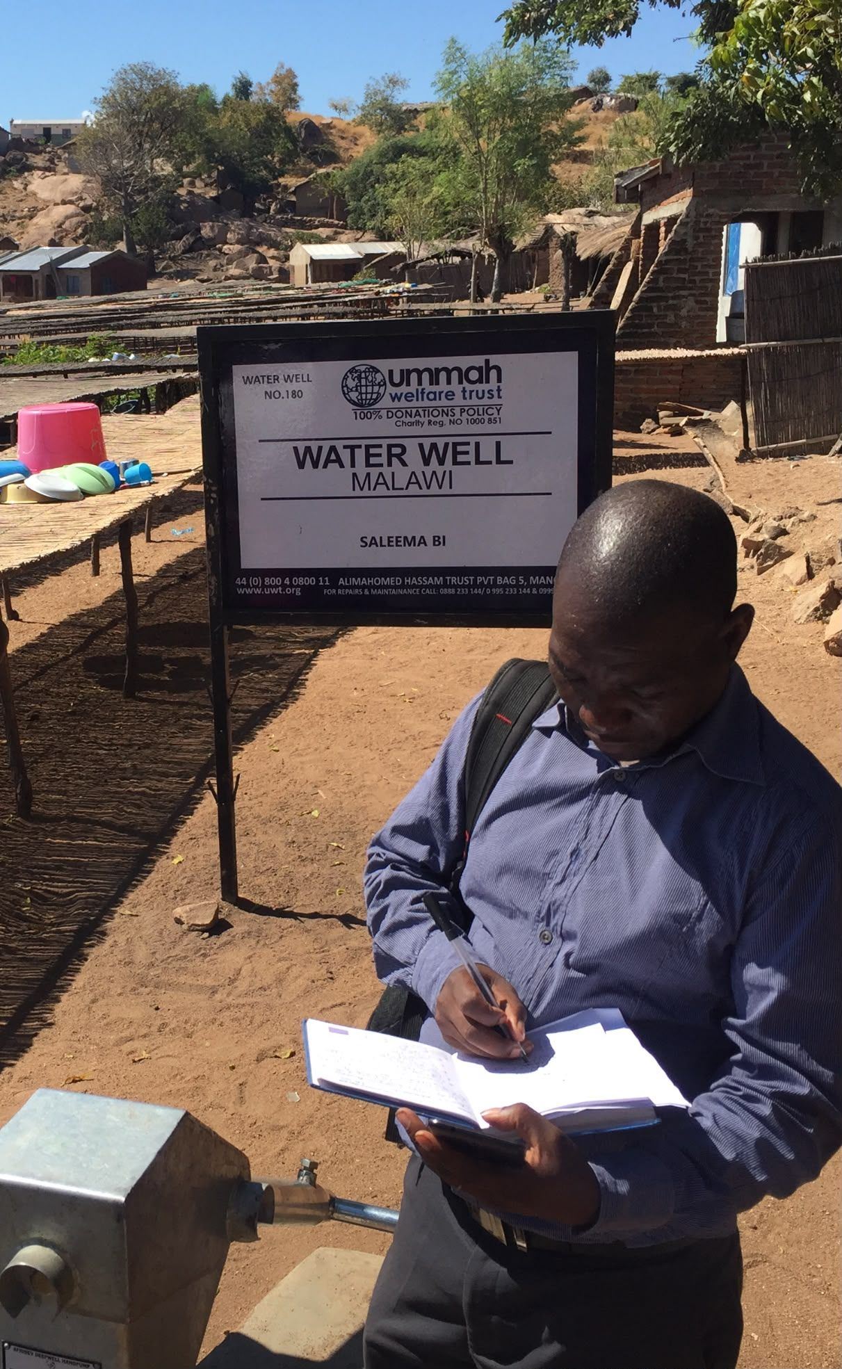 Field team recording observations at a village water point